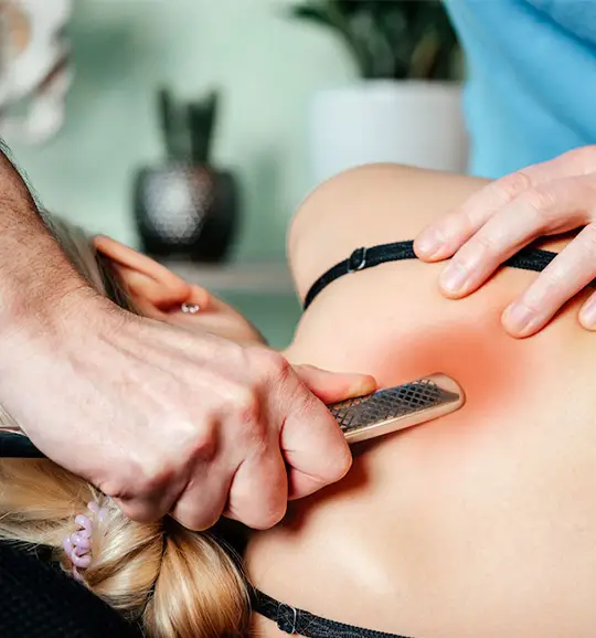 A therapist using a comb to relieve neck tension.