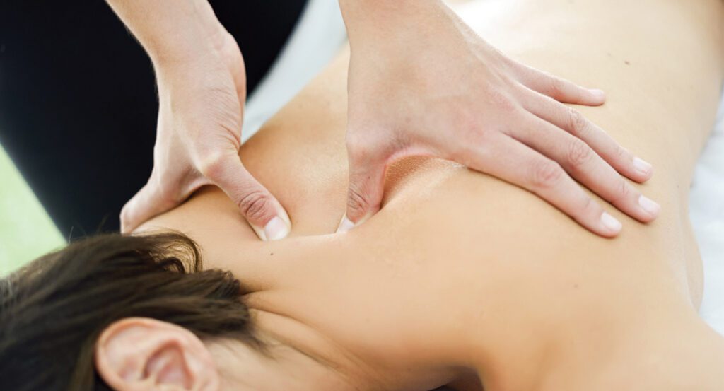 Therapist applying firm shoulder blade pressure